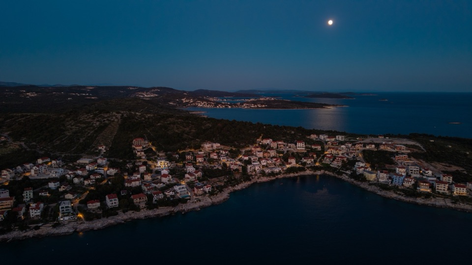 Dalmatian coastline at night under a full moon